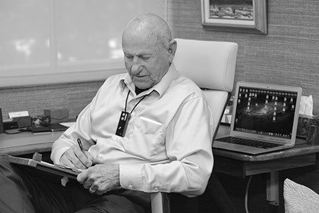 Dr. Yager writing at his desk